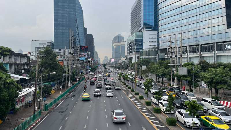 A Bangkok city street around rush hour