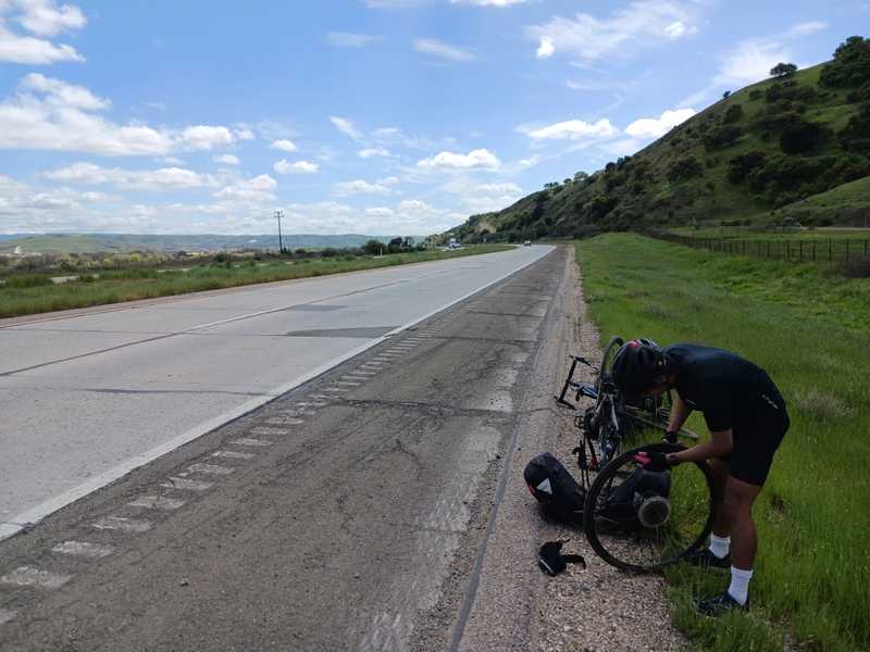 Fixing a flat on the shoulder of the 101. I'm learning! Photo by Elliot Klein.